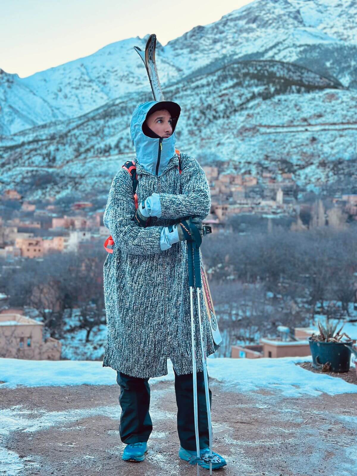 Radouane carrying skis through the Atlas Mountains