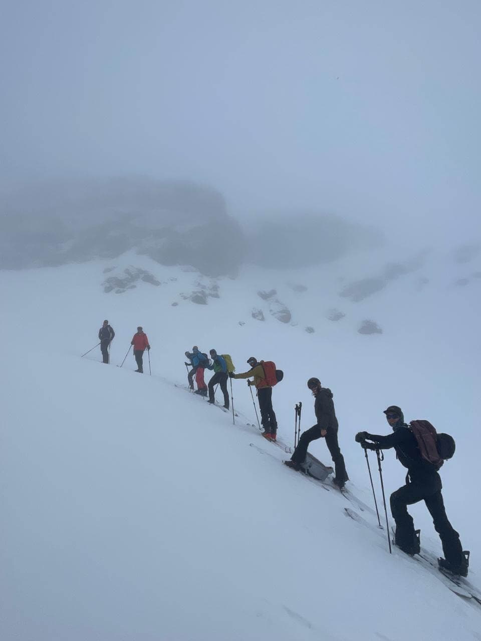 Ski touring group in high mountain terrain near Tadat