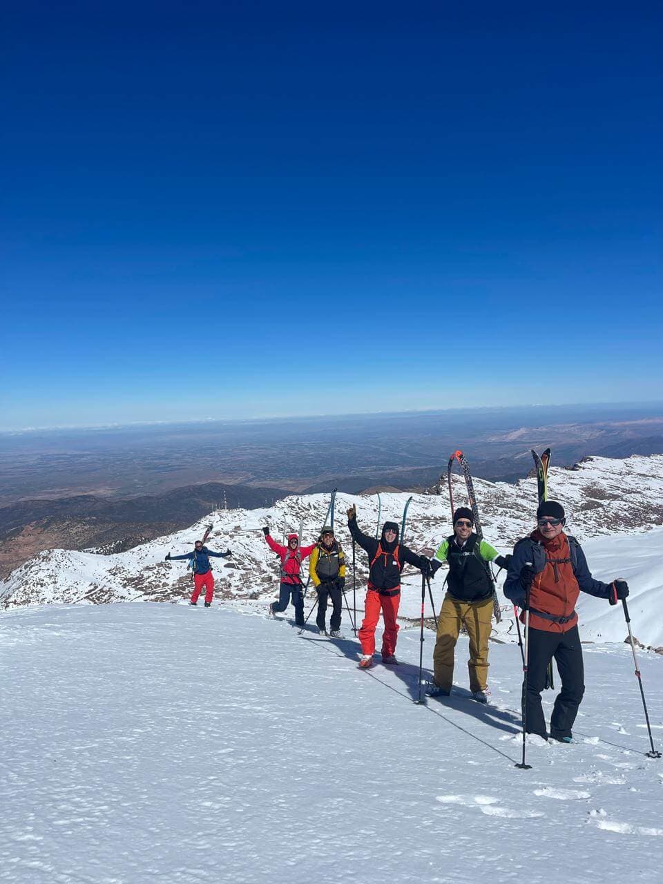 Skiers ascending snow slopes during a ski touring expedition towards M'Goun