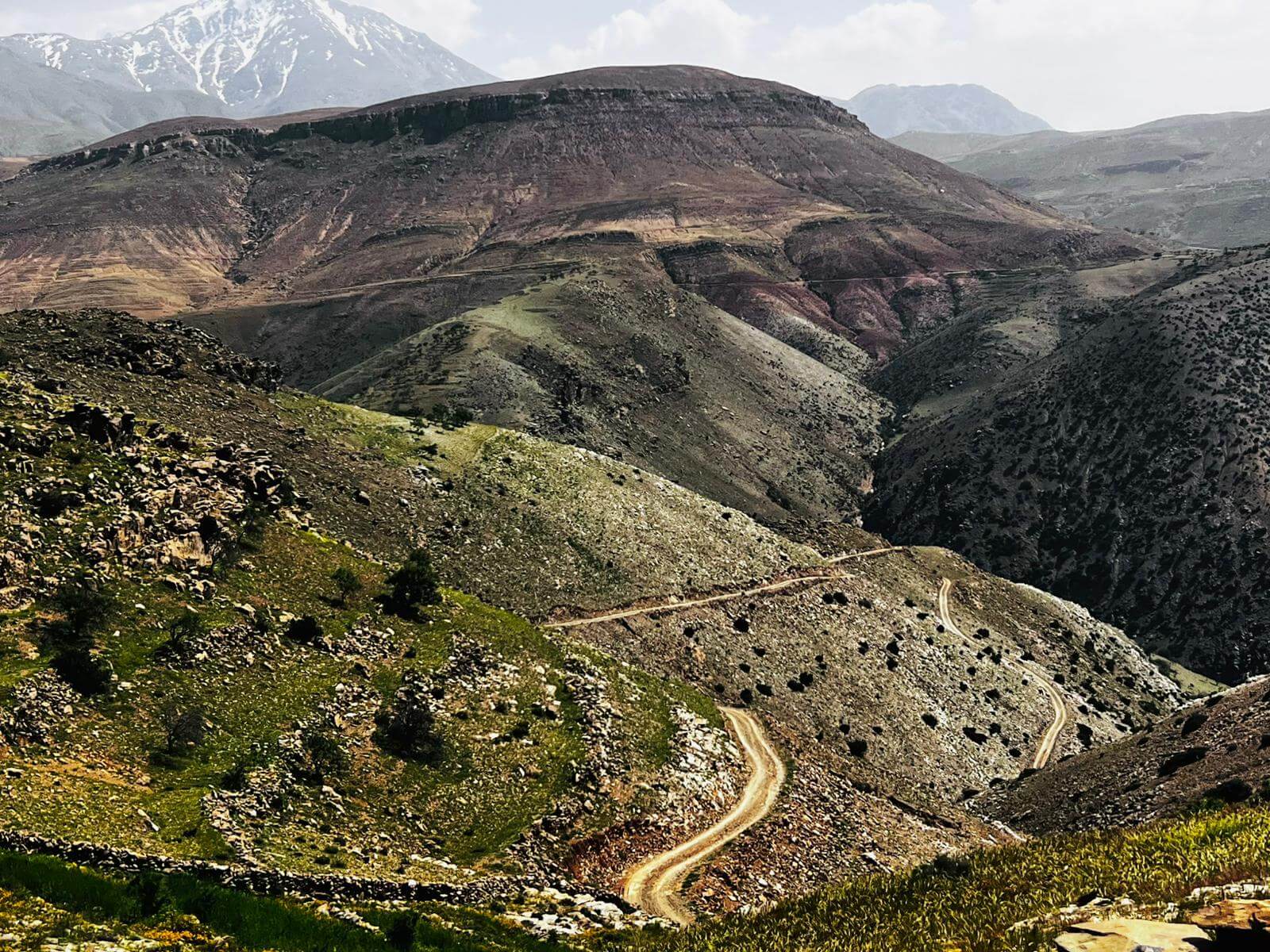 Mountain bike riding on a remote dirt road through the Moroccan mountains