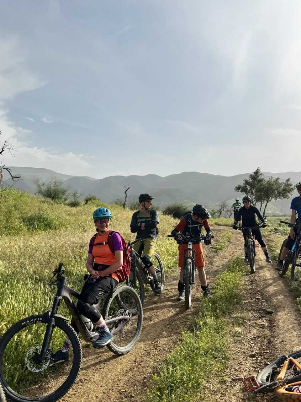 Mountain bike group riding through a green valley in Morocco