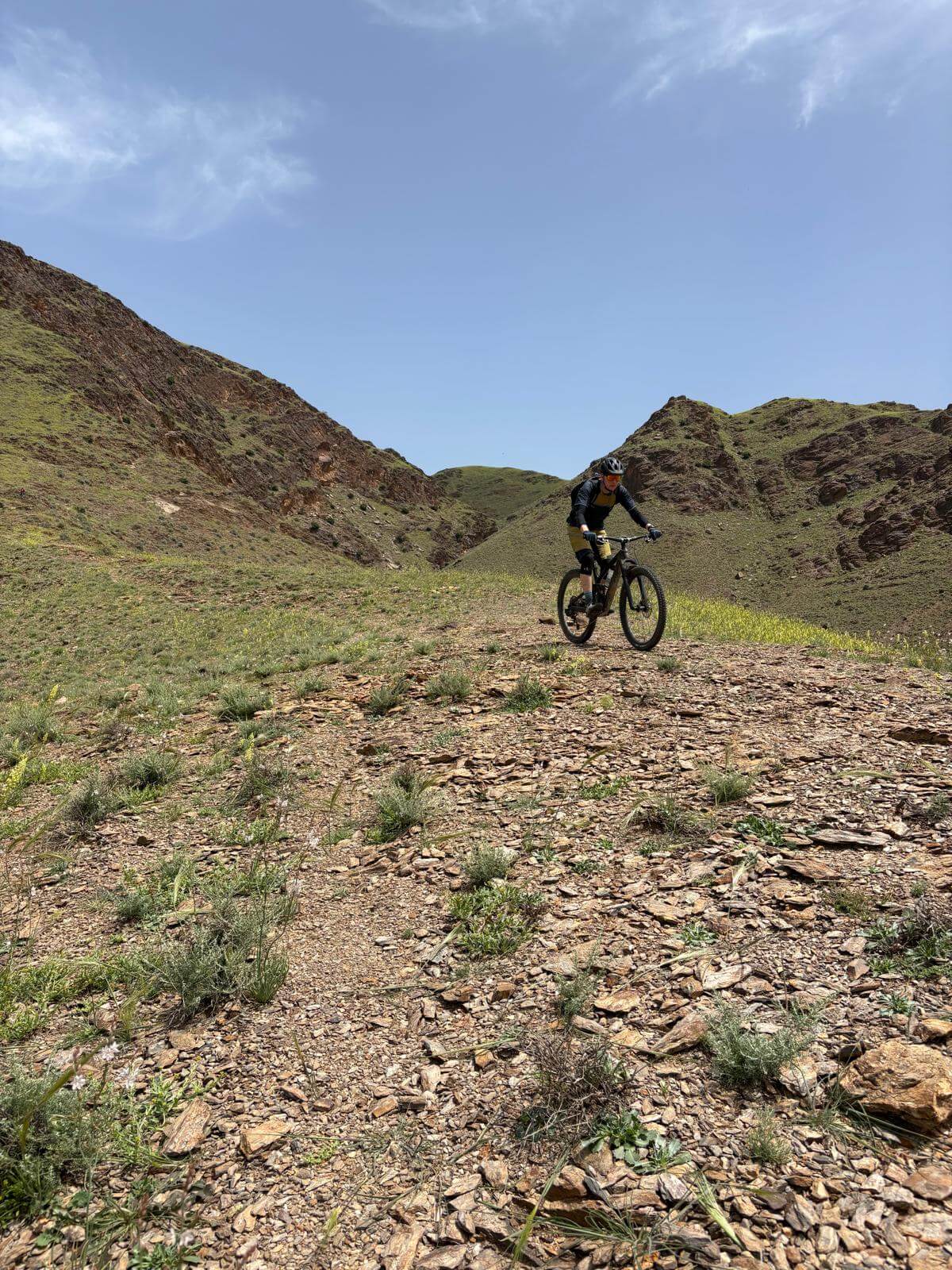 Mountain biker riding a rocky mountain trail in Morocco