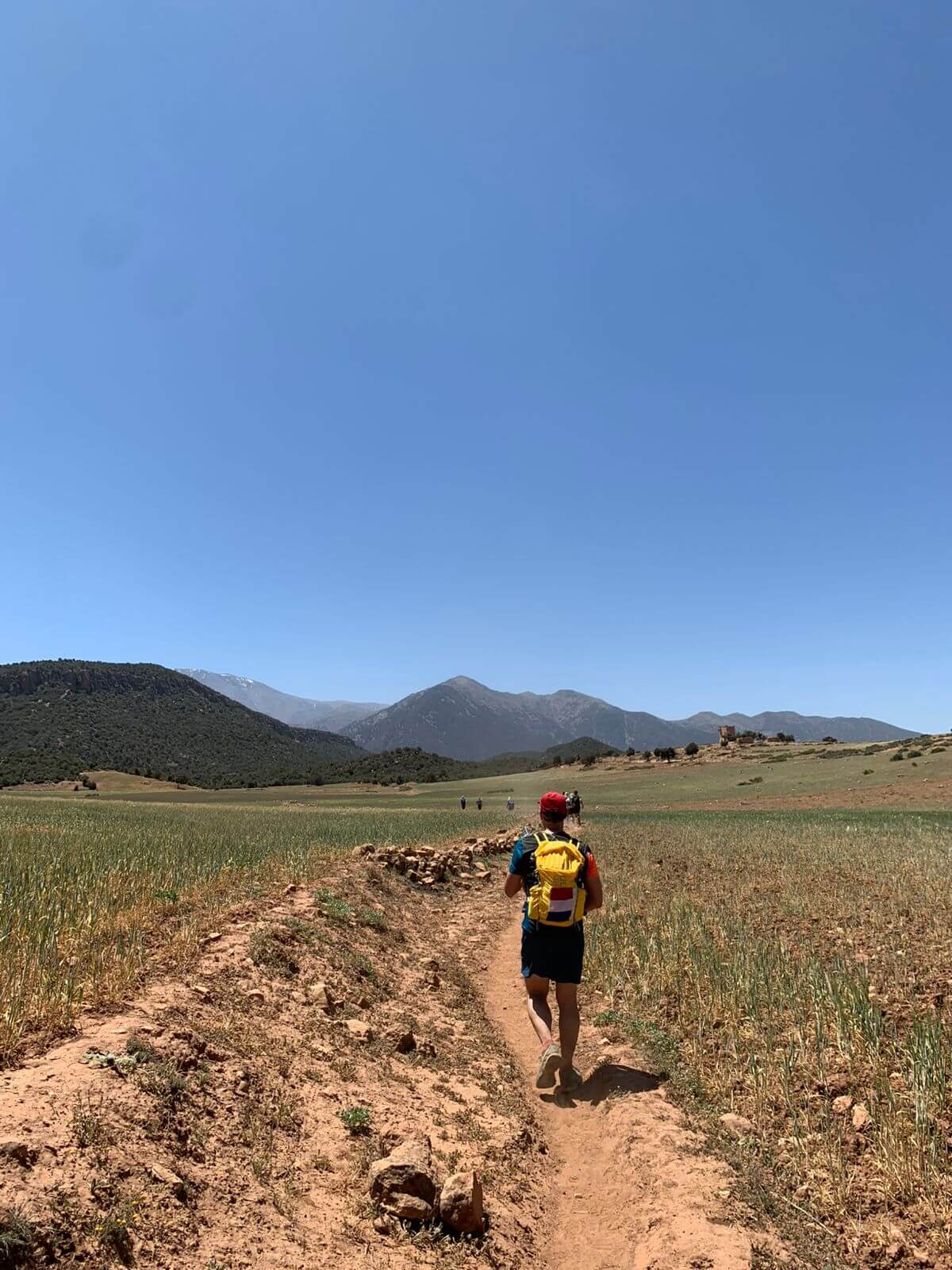 Trail Running from Moulay Brahim to Ouirgane — High Atlas Mountains Trail runner on the mountain trail between Moulay Brahim and Ouirgane in Morocco's High Atlas Mountains