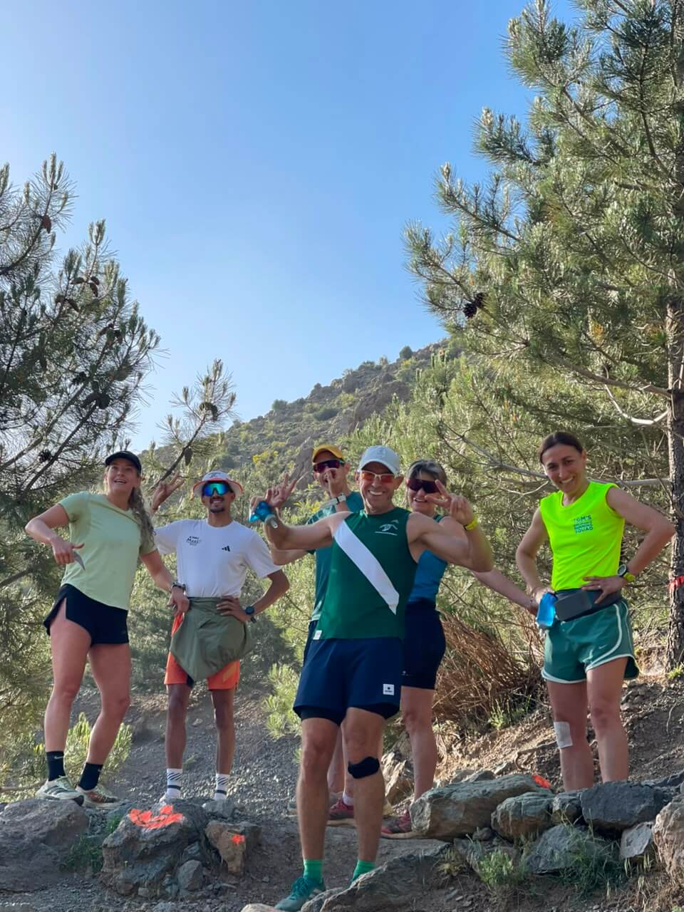 Radouane Outdoor leading a group of trail runners through Tizi Mzik forest in Morocco's High Atlas