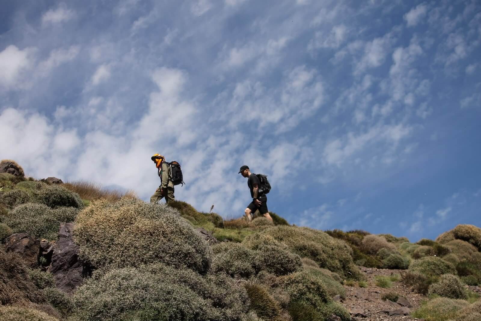 Trekker crossing a high mountain pass in Morocco's Toubkal Massif